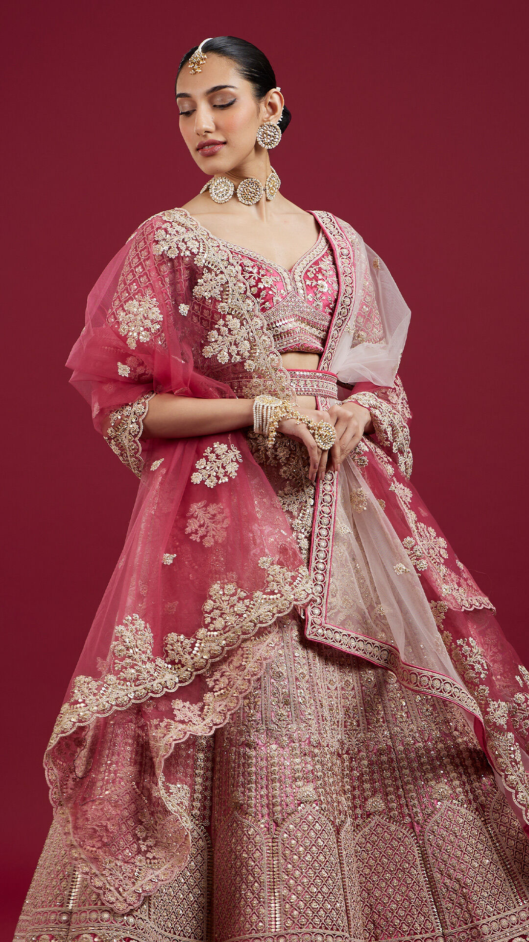 A Zari Embroidered Rani Pink Bridal Lehenga with matching blouse